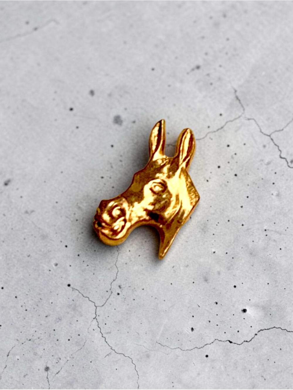 Vintage gold-tone figural donkey head pin presented on its original card